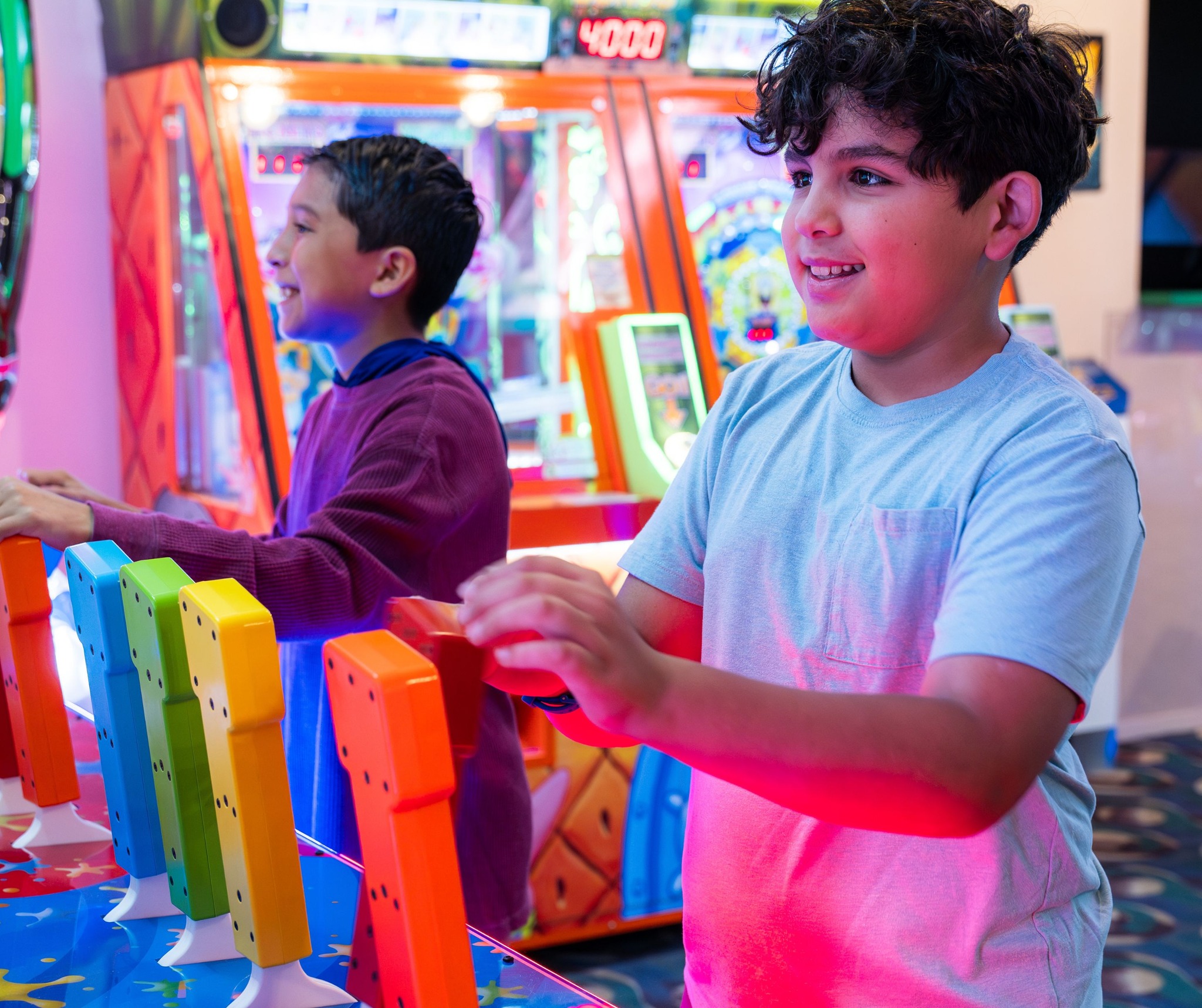 two boys playing a game with color handles